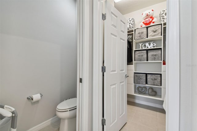 bathroom with tile flooring and toilet