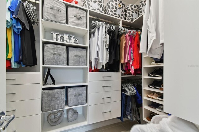 spacious closet featuring tile flooring