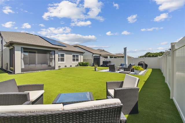 rear view of property with a patio, an outdoor hangout area, a yard, and solar panels