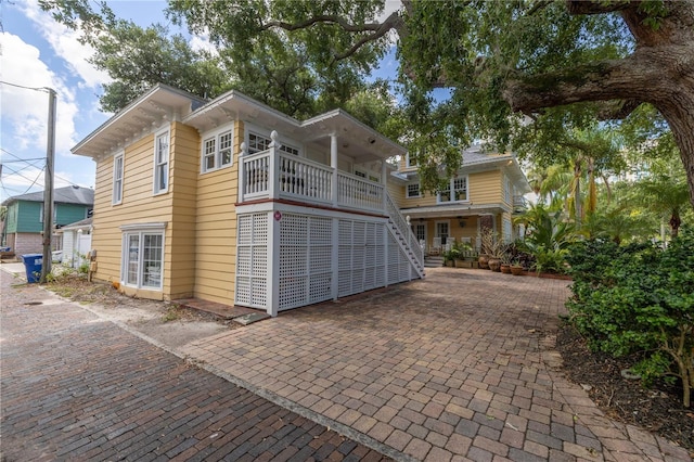 rear view of property with covered porch