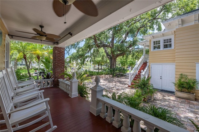 wooden terrace with ceiling fan and a porch