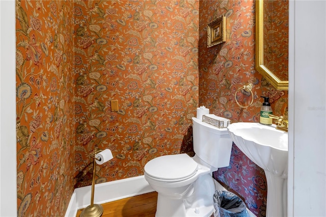 bathroom featuring hardwood / wood-style flooring and toilet