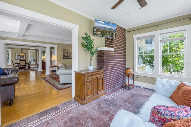 living room with crown molding, ceiling fan, hardwood / wood-style floors, decorative columns, and beamed ceiling