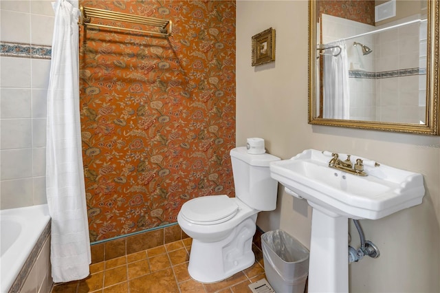 bathroom featuring shower / tub combo, tile patterned floors, and toilet