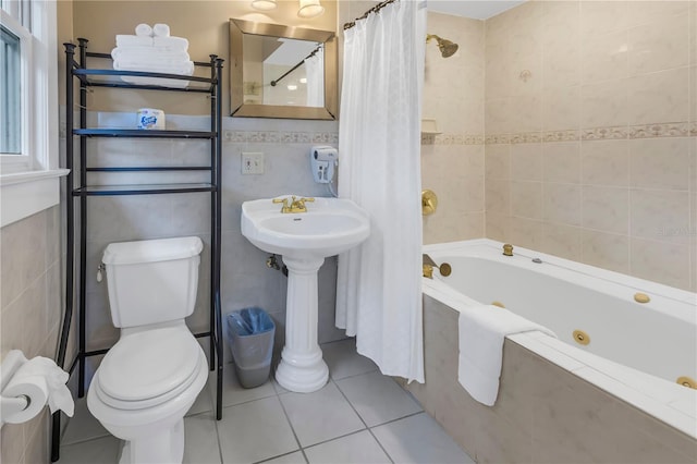 bathroom featuring tile walls, tile patterned floors, toilet, and shower / bath combo with shower curtain