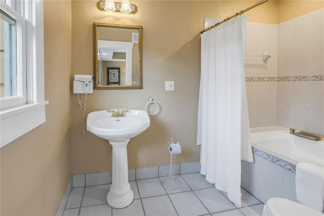 bathroom featuring shower / bathtub combination with curtain and tile patterned floors