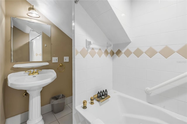 bathroom with shower / tub combo with curtain, tile patterned floors, and lofted ceiling