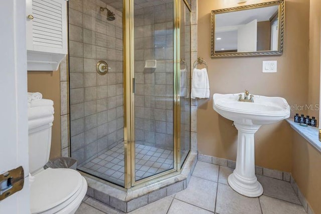 bathroom with walk in shower, toilet, and tile patterned flooring