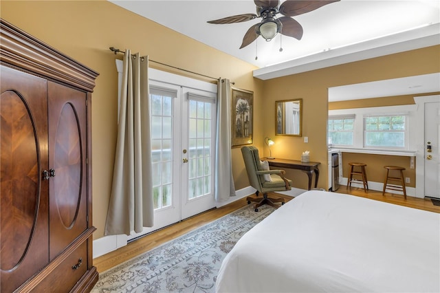 bedroom with light wood-type flooring, access to exterior, ceiling fan, and french doors