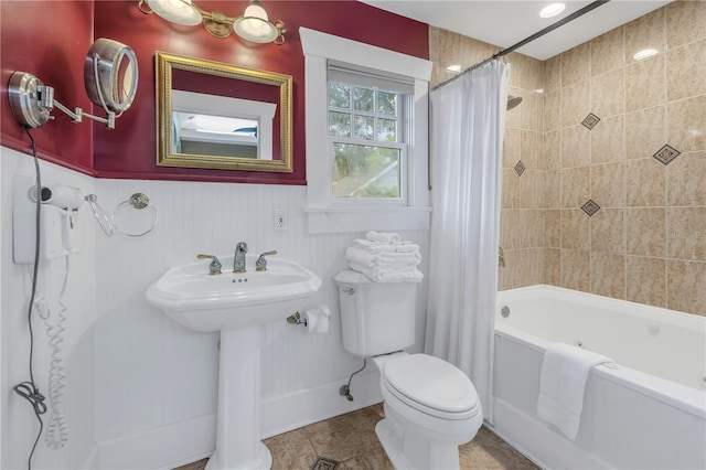 full bathroom with shower / tub combo with curtain, tile patterned floors, toilet, and sink