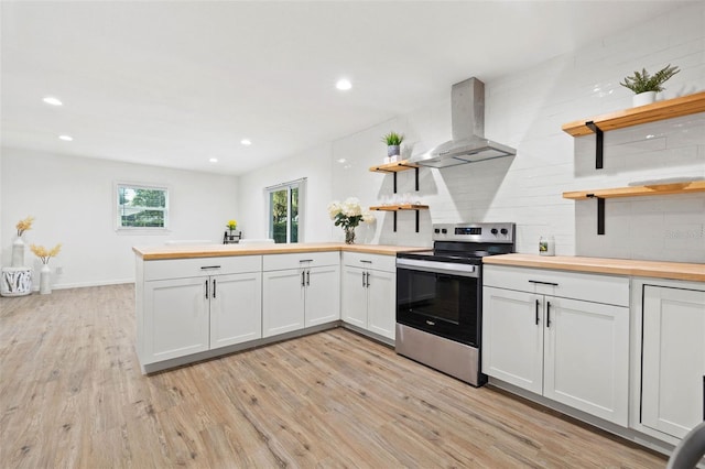 508 Brooker Rd, Brandon, FL 33511 - kitchen featuring wall chimney range hood, a peninsula, electric range, wood counters, and open shelves