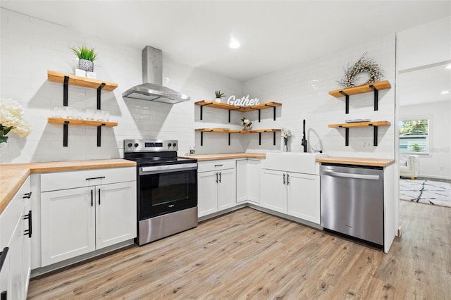 508 Brooker Rd, Brandon, FL 33511 - kitchen featuring open shelves, stainless steel appliances, wooden counters, and wall chimney range hood