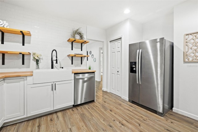 508 Brooker Rd, Brandon, FL 33511 - kitchen featuring wooden counters, open shelves, light wood-style floors, stainless steel appliances, and a sink