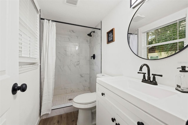 508 Brooker Rd, Brandon, FL 33511 - full bath with visible vents, toilet, wood finished floors, and a tile shower