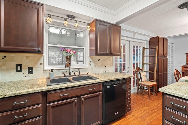 kitchen with black dishwasher, sink, decorative backsplash, ornamental molding, and light hardwood / wood-style floors