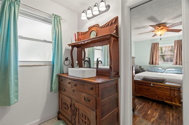 bathroom featuring ceiling fan, wood-type flooring, and vanity