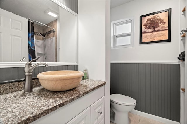 bathroom with tile patterned floors, vanity, toilet, and a shower with shower curtain