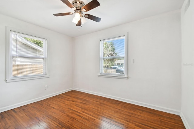 unfurnished room with a wealth of natural light, ceiling fan, and wood-type flooring