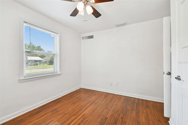 empty room with ceiling fan and dark wood-type flooring