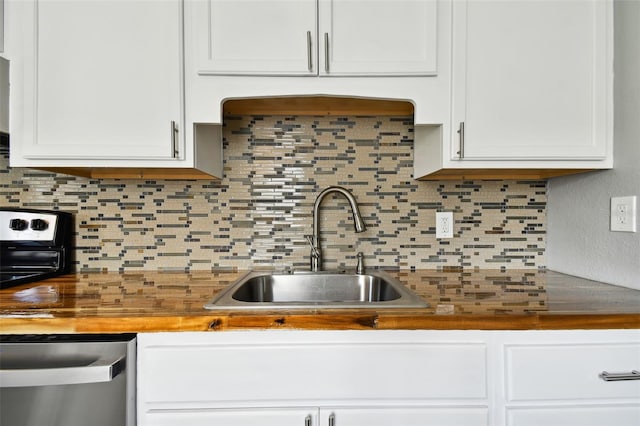 kitchen featuring stainless steel dishwasher, decorative backsplash, white cabinets, and sink