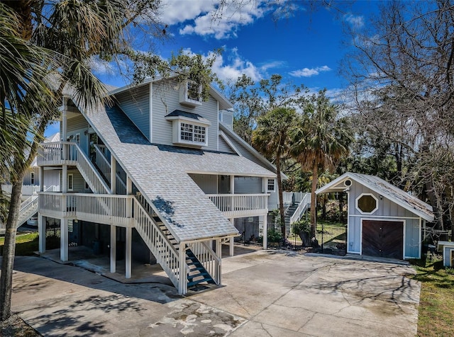 rear view of property featuring a garage and an outdoor structure