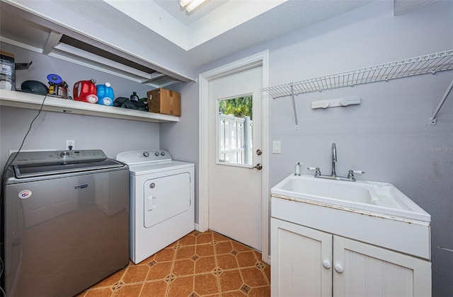 laundry area featuring washing machine and clothes dryer and sink