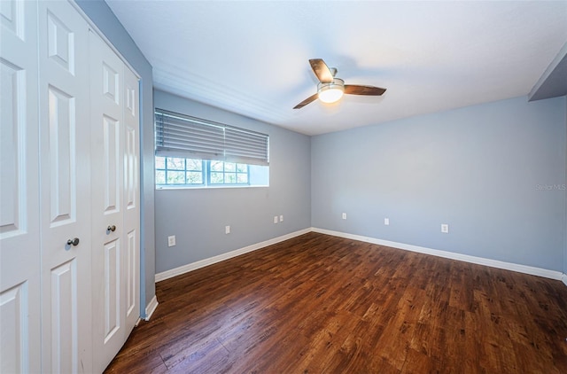 interior space with dark hardwood / wood-style floors and ceiling fan