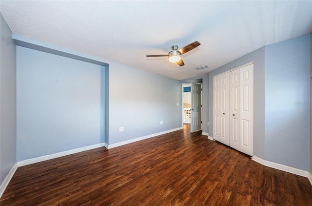 unfurnished bedroom with a closet, ceiling fan, and dark hardwood / wood-style flooring