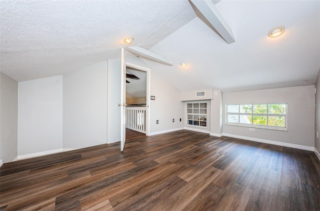 unfurnished living room with a textured ceiling, dark hardwood / wood-style flooring, and vaulted ceiling