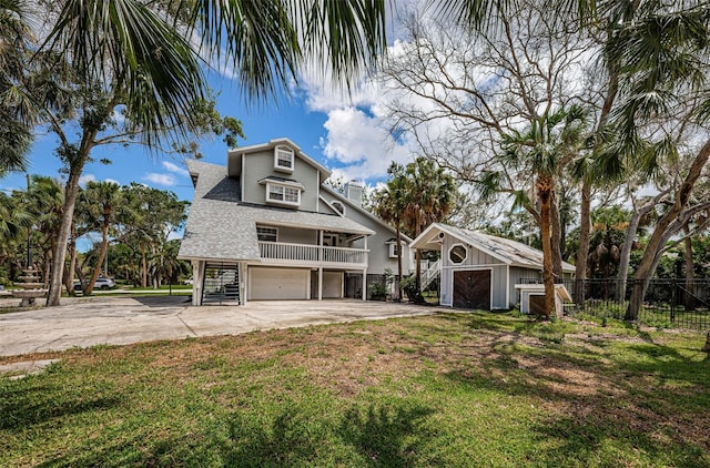 view of front of home with a garage and a front lawn