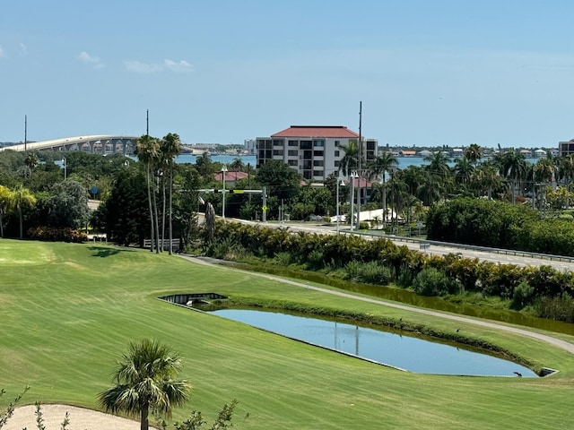 view of property's community featuring a water view and a lawn