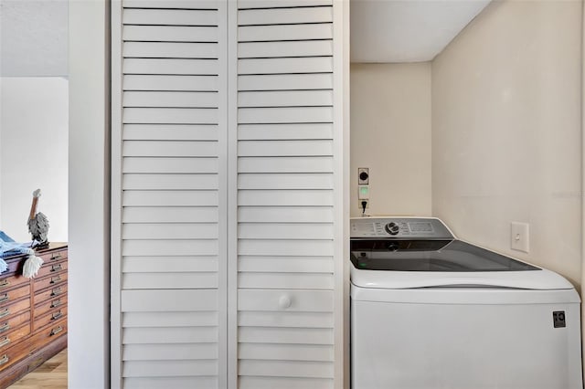 laundry area featuring wood-type flooring and washer / dryer