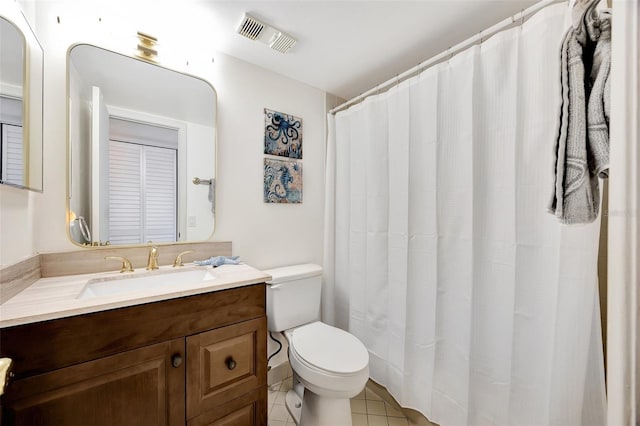 bathroom featuring tile patterned floors, vanity, and toilet