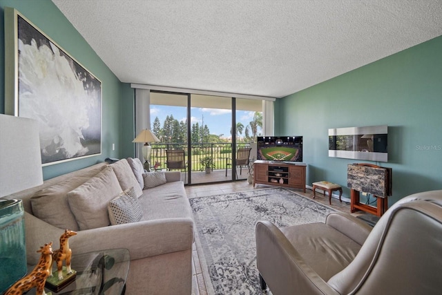 living room with floor to ceiling windows and a textured ceiling