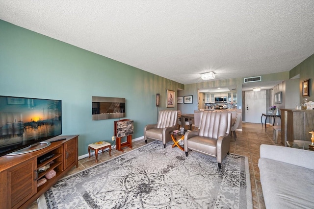 living room featuring tile patterned floors and a textured ceiling