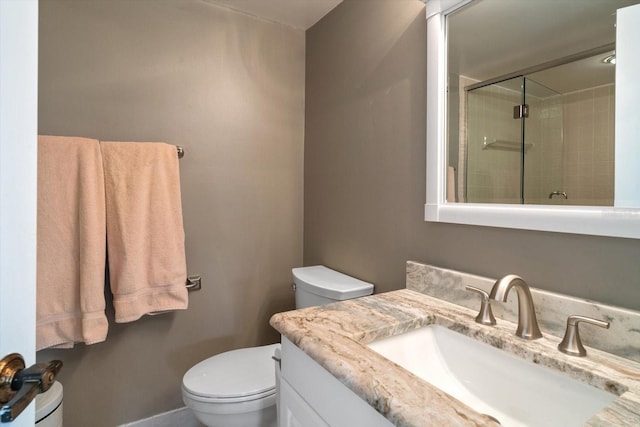 bathroom with vanity, toilet, and walk in shower