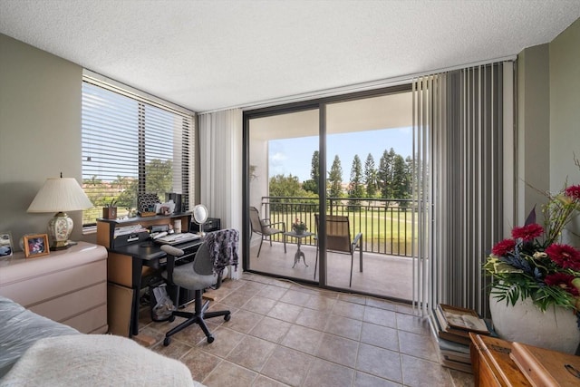 office area featuring light tile patterned flooring and a textured ceiling