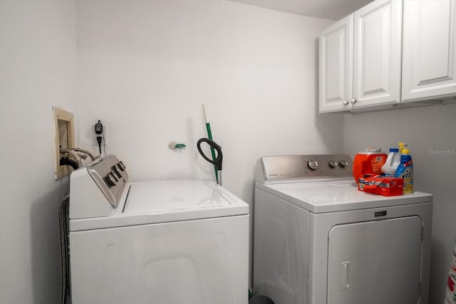 laundry area featuring cabinets and washing machine and clothes dryer