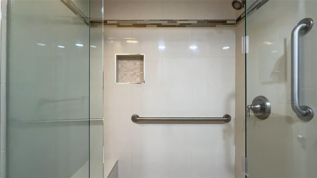 bathroom with a shower with door