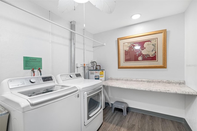 laundry area with washing machine and clothes dryer, electric water heater, and dark hardwood / wood-style flooring