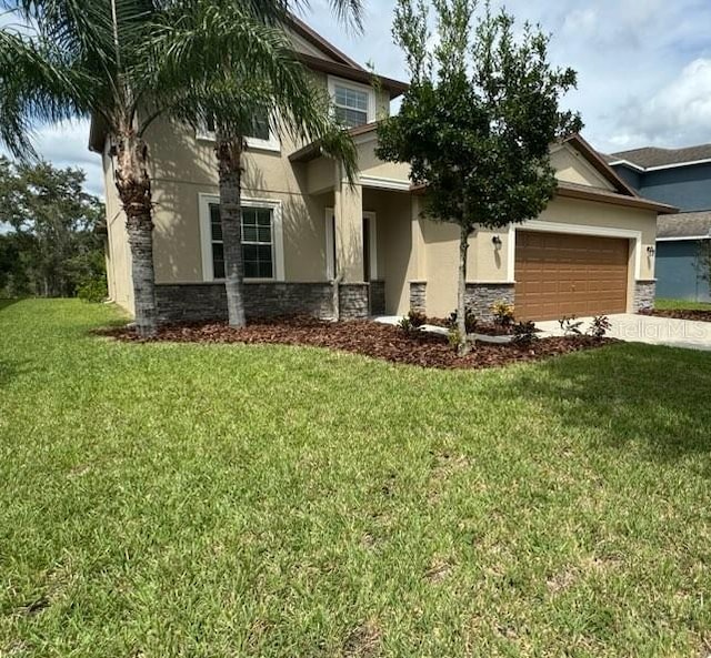 view of front of home featuring a front lawn and a garage