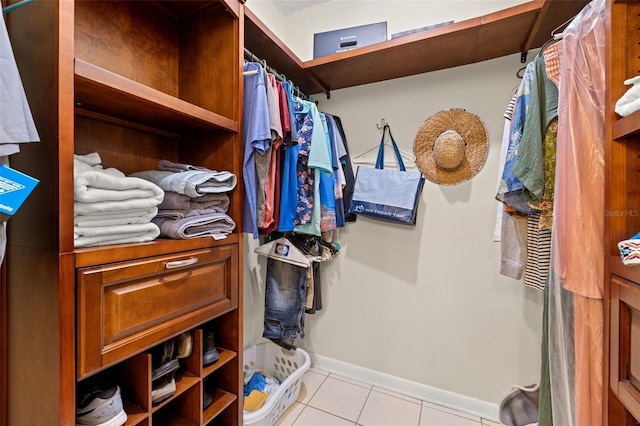 walk in closet featuring light tile patterned flooring