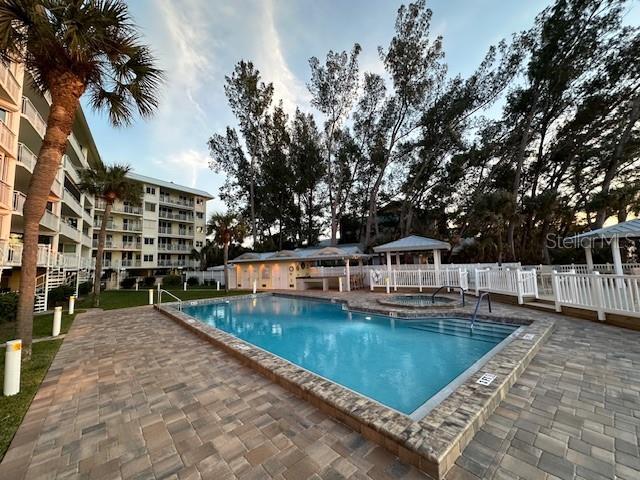 view of pool with a community hot tub and a patio