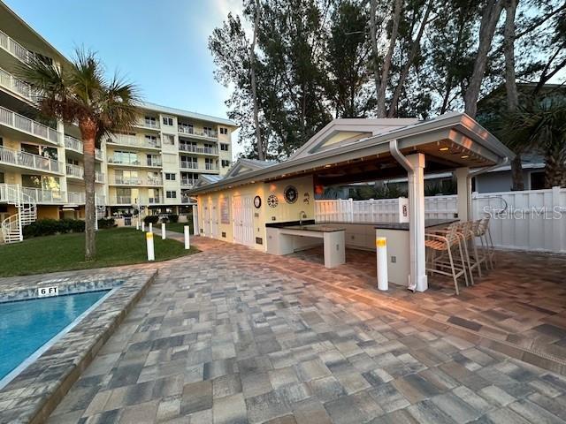 view of property's community featuring a pool and a patio