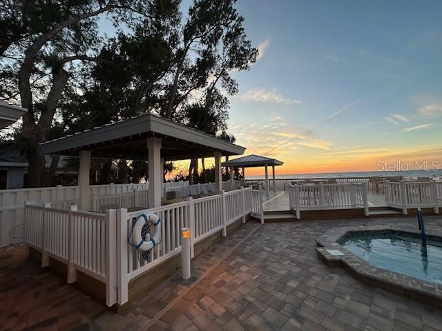 patio terrace at dusk featuring a gazebo