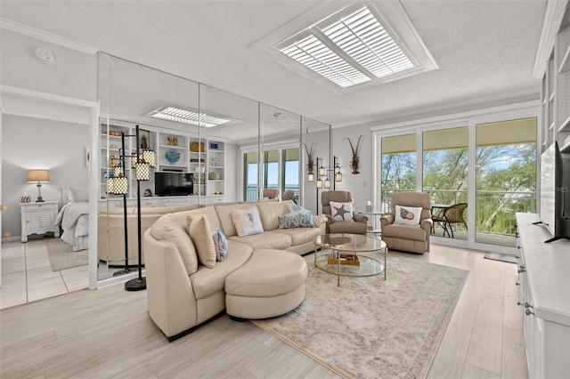 living room featuring crown molding, a textured ceiling, and light hardwood / wood-style flooring