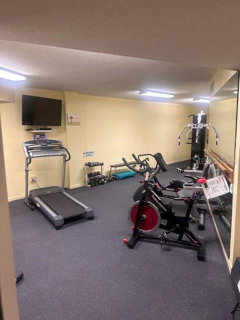 workout area featuring a textured ceiling