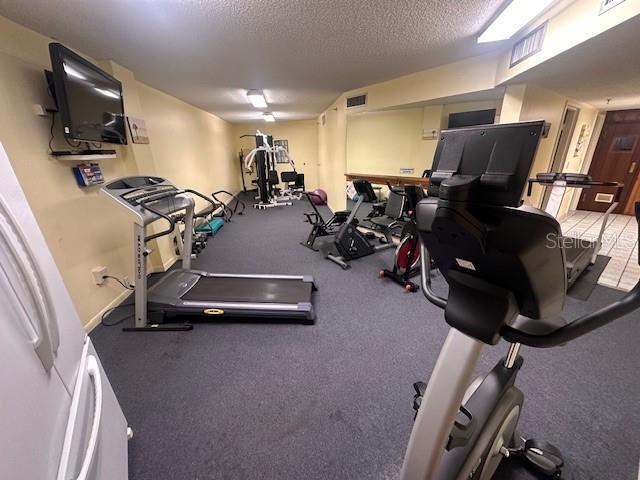 workout area featuring a textured ceiling