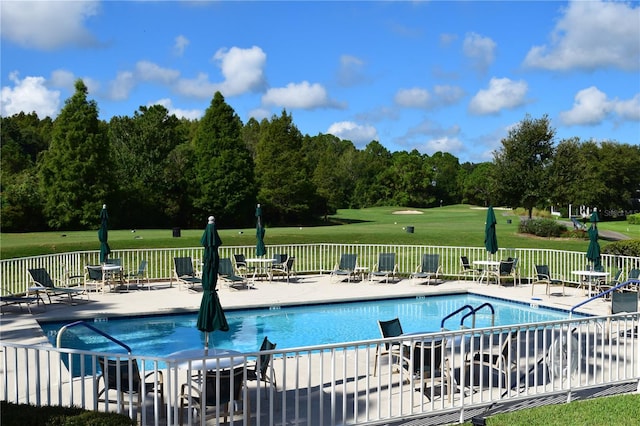 view of pool with a lawn and a patio area