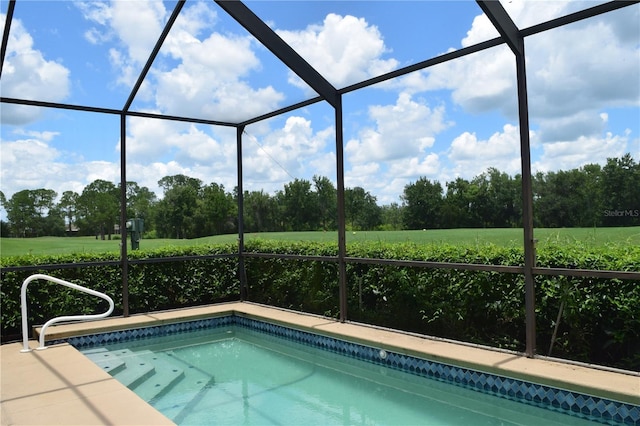 view of pool with a lanai and a rural view